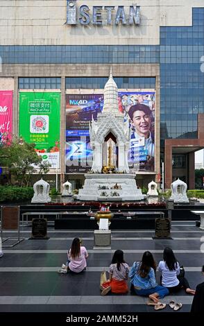 bangkok, thailand - 2020.01.12: trimurti shrine at ratchaprasong in front of central world shopping mall  / isetan department store Stock Photo