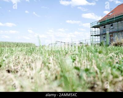 Scaffolded residential house under construction in the industrial area West in Maisach. [automated translation] Stock Photo