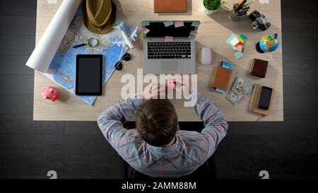 Male worker writing note on colourful sticker, creative idea for startup project Stock Photo