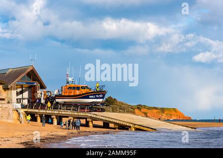 EXMOUTH, DEVON, UK - 3APR2019: RNLB R & J Welburn, a Shannon Class lifeboat, being lowered down the slipway by tractor, during a regular exercise. Stock Photo
