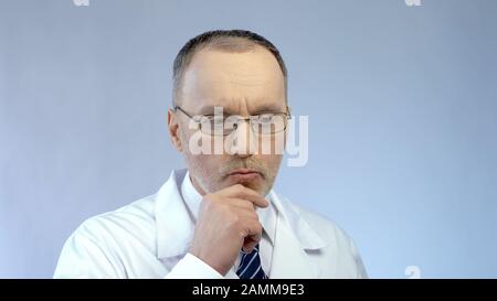 Male scientist thinking over project, solving problem in medical research Stock Photo