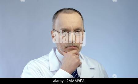 Serious face of male therapist or scientist thinking hard about complex problem Stock Photo