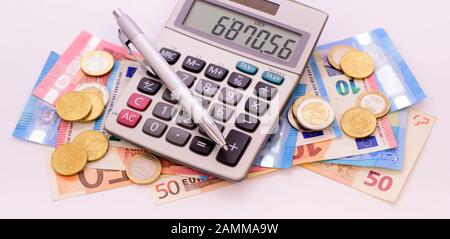 Euro banknotes and calculator [automated translation] Stock Photo