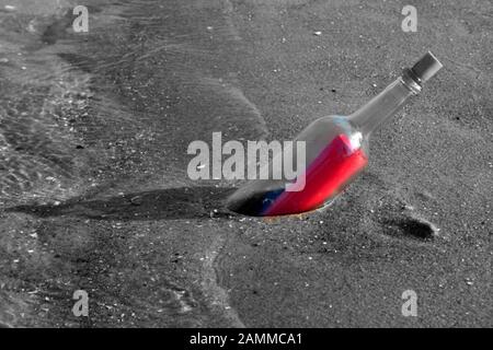 black and white picture of a message in a bottle. Red stained letter. [automated translation] Stock Photo