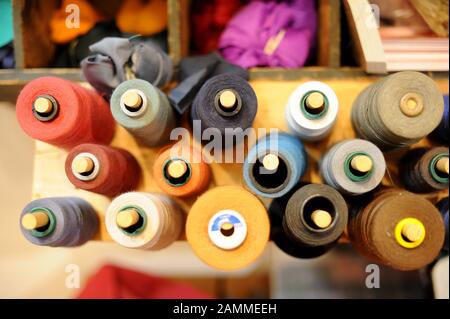 In the mobile repair workshop "Worn Wear Mobil" of Patagonia in Munich's Leopoldstrasse you can repair your clothes. In the picture different coloured yarn rolls. [automated translation] Stock Photo