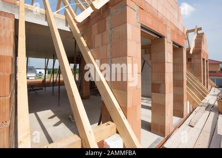 House building in shell with bricks and roof truss [automated translation] Stock Photo