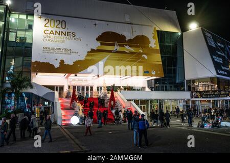 Cannes France, 28 December 2019 : Tourists on Cannes film festival red carpet stairs and 2020 board at night in Cannes France Stock Photo