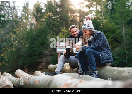 Father and son drinking hot tea in the autumn forest Stock Photo
