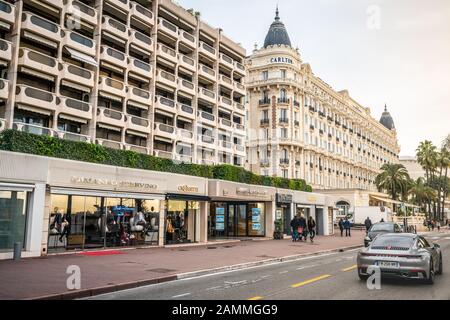 Cannes France, 29 December 2019 : Boulevard de la Croisette street view with luxury shops and Intercontinental Carlton hotel in Cannes France Stock Photo