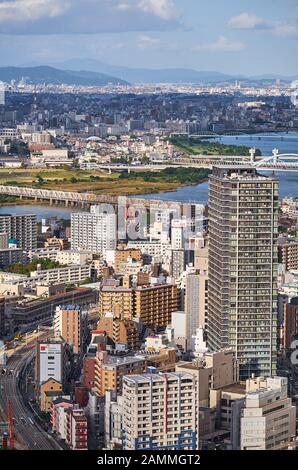 OSAKA, JAPAN - OCTOBER 15, 2019: The view from the top of Umeda Sky Building on the skyscrapers in the Kita (north) downtown with Yodo River on the ba Stock Photo