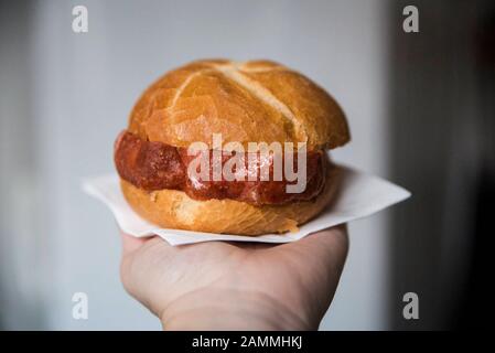 Food style of a Leberkässemmel in the hand. [automated translation] Stock Photo