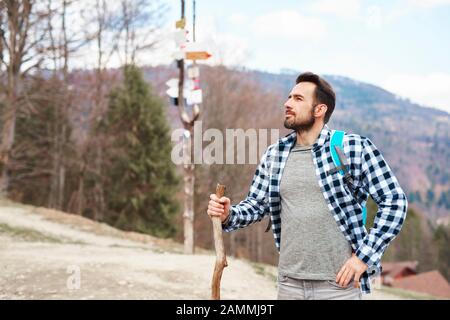 Handsome man is backpacking in the mountains Stock Photo