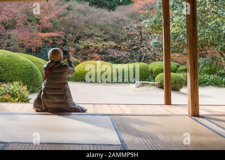 KYOTO, JAPAN - NOV 25 :Tourists enjoy watching maple leaf in zen garden at Japanese temple on November 25,2016 in Kyoto,Japan Stock Photo