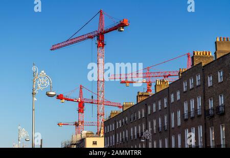 Building cranes for construction in Dublin, Ireland. ESB Project Fitzwilliam, redevelopment with terrace of historic Georgian architecture Stock Photo