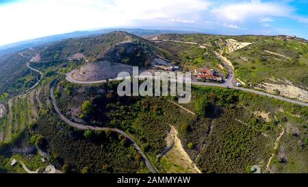 Sole roadside hotel for tourists in mountains, terraced hills with olive trees Stock Photo