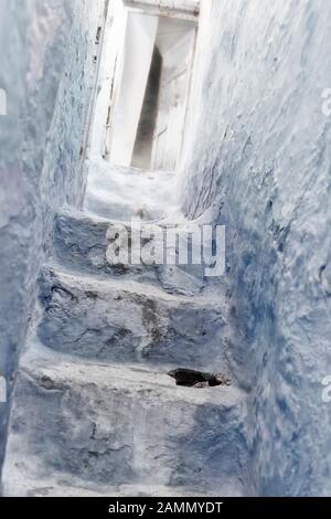 Stone staircase with old, wooden door in the medina of Chefchaouen, Morocco. Stock Photo