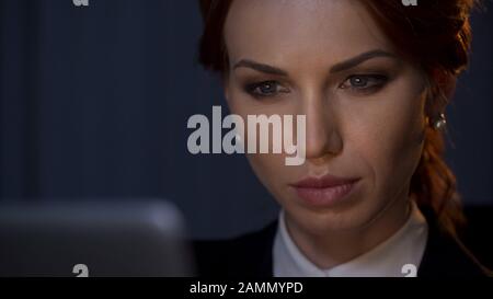 Close up of confident businesswoman looking at laptop screen in company office Stock Photo