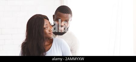 Young joyful married couple posing over white background Stock Photo