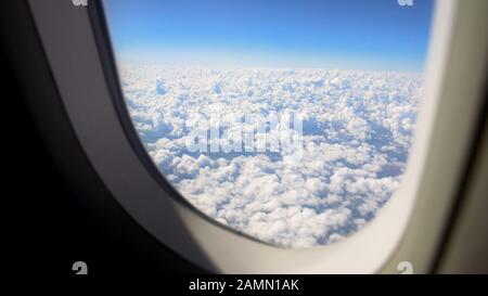 Fluffy cloudscape viewed from airplane window, beautiful nature, vacation trip Stock Photo