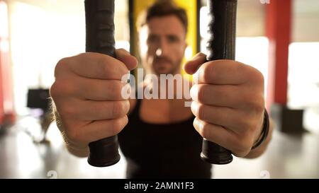 Male with highly developed muscles doing chest fly workout gym, hands close-up Stock Photo