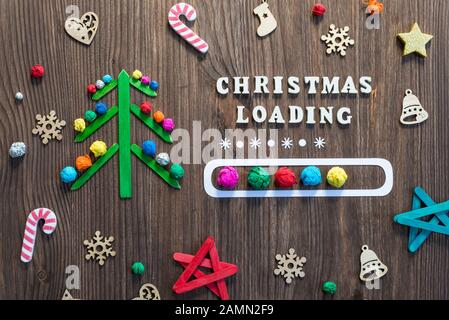 colorful christmas tree with loading bar concept on wooden background Stock Photo