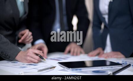 Managers discussing company development plan, considering business strategy Stock Photo