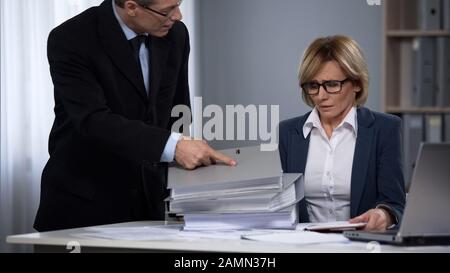 Female staff member of law firm overloaded with paper work, overtime labor Stock Photo