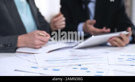 Managers checking information in tablet, online register, technology in business Stock Photo