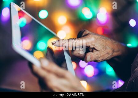Closeup on elderly woman using a digital tablet Stock Photo
