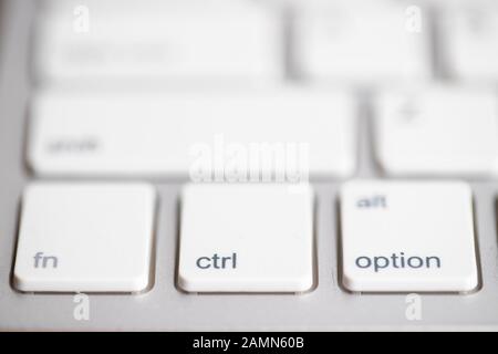 three buttons close up computer white keyboard and others blur keys, function, control and option button, use for command action program Stock Photo