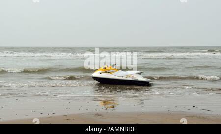 Electric personal watercraft vehicle for Jet skiing Water sports enthusiast in an empty sea beach. Jet skiing is sport racing over a body of water. A Stock Photo