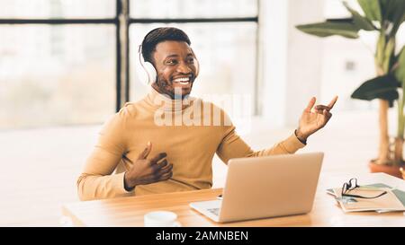Young african businessman listening to rock with headset Stock Photo