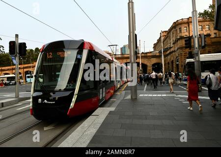 The Sydney light rail train cruises past Central Railway Station. Stock Photo