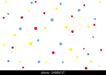 red blue yellow water colour random drop dots on white drawing paper with paper texture. Stock Photo