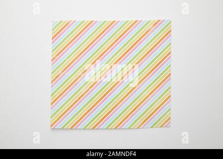 top view of empty crumpled and burnt paper with colorful lines on white background Stock Photo