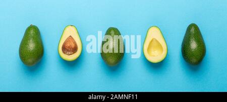 Eco disposable single up cutlery with avocado seeds on blue Stock Photo