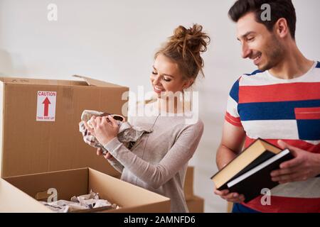 Happy couple packing their stuff into boxes Stock Photo