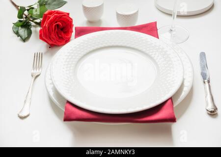 Valentine's day or birthday dinner. Elegance table setting with red rose and decor. Close up. Stock Photo