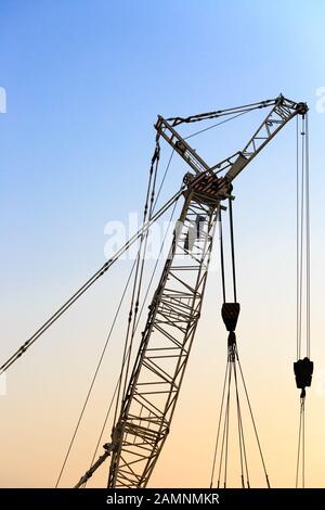 silhouette of metal crane used in construction crane close-up Stock Photo