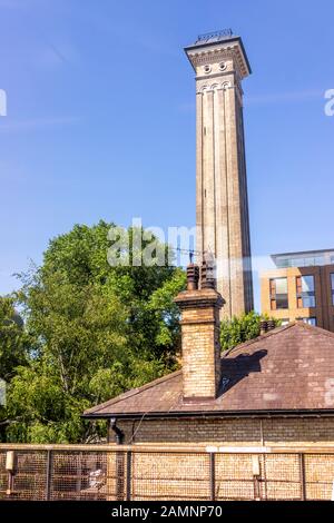 London, UK Industrial railroad transport in United Kingdom, Pimlico neighborhood district Victoria station with tower and house chimney on roof Stock Photo
