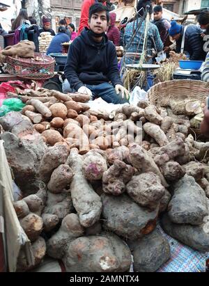 Kathmandu, Nepal. 14th Jan, 2020. A vendor sells yam, locally known as tarul, on the eve of Maghe Sankranti festival at a local market of Ason in Kathmandu, Nepal, Jan. 14, 2020. Nepalese people consume various kinds of yams, either boiled or with some condiments, in celebration of Maghe Sankranti festival and even to welcome winter season. Credit: Sunil Sharma/Xinhua/Alamy Live News Stock Photo