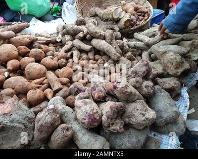 Kathmandu, Nepal. 14th Jan, 2020. A vendor sells yam, locally known as tarul, on the eve of Maghe Sankranti festival at a local market of Ason in Kathmandu, Nepal, Jan. 14, 2020. Nepalese people consume various kinds of yams, either boiled or with some condiments, in celebration of Maghe Sankranti festival and even to welcome winter season. Credit: Sunil Sharma/Xinhua/Alamy Live News Stock Photo