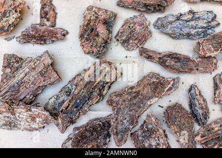 Closeup flat top view of wood chips bark peel for gardening mulch for orchids on table showing texture Stock Photo