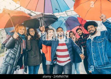Friends making the best of rain and bad weather Stock Photo