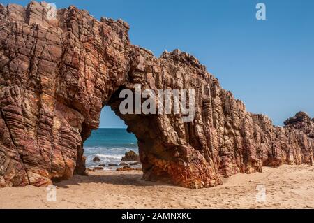 Holed stone at Jericoacoara Beach, Northeastern Brazil, State of Ceara Stock Photo