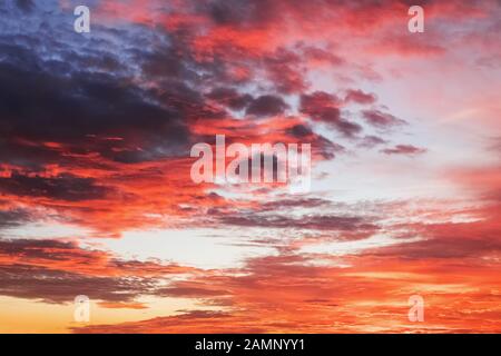 Beautiful dramatic red sunset sky with stormy clouds. Stock Photo