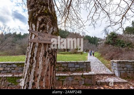 Sign pointing to a local fountain in the region saying that it is very cool and soothing near Vytina, Arcadia, Greece Stock Photo