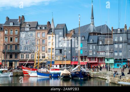 Honfleur, Normandy, France - 26 March 2019: The old port of Honfleur, Normandy, France, showing the colorful old houses and the many boats and yachts Stock Photo