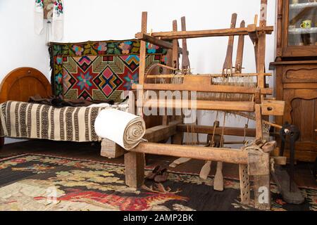 Old traditional wooden weaving loom on old traditional Romanian house Stock Photo