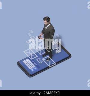 Business executive logging in into his phone and checking his messages, communication and technology concept Stock Photo